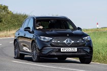 Mercedes GLC (2023) review: front three quarter cornering, black car, rural B-road