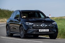 Mercedes GLC (2023) review: front three quarter driving, black car, rural B-road