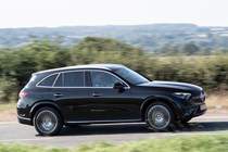 Mercedes GLC (2023) review: side view driving, black car, rural B-road