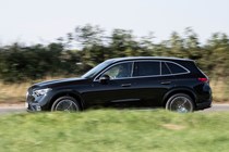 Mercedes GLC (2023) review: pan shot driving, black car, rural B-road
