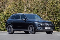 Mercedes GLC (2023) review: front three quarter static, black car, trees in background