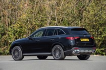 Mercedes GLC (2023) review: rear three quarter static, black car, trees in background