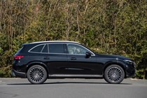 Mercedes GLC (2023) review: side view static, black car, trees in background