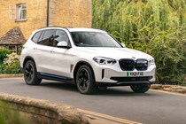 BMW electric cars - iX3 driving over bridge, white, front view