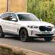 BMW electric cars - iX3 driving over bridge, white, front view