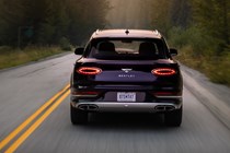 Bentley Bentayga EWB review - dead-on rear view, purple, driving