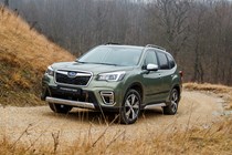 Subaru Forester (2022) review - front three quarter, green car, driving up a dirt road