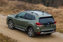 Subaru Forester (2022) review - rear pan shot, green car, driving along a dirt road