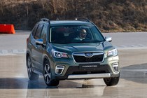 Subaru Forester (2022) review - front cornering on a wet skid pan, green car, showing body roll