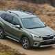 Subaru Forester (2022) review - front pan shot, green car, dirt road