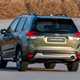 Subaru Forester (2022) review - rear cornering shot, green car, body roll