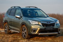 Subaru Forester (2022) review - front three quarter static on a grass field, green car