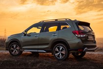 Subaru Forester (2022) review - rear three quarter static, green car, sunset background