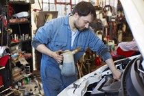 Man in overalls with oil