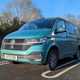 Volkswagen Transporter long-term review (2023): badly parked in a Sainsbury's car park, front three quarter static
