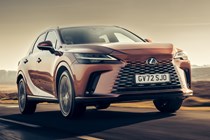 Lexus RX 450h+ (2023) review: front three quarter driving, bronze car, sunrise country road
