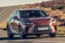 Lexus RX 450h+ (2023) review: front three quarter cornering, bronze car, country road