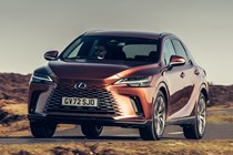 Lexus RX 450h+ (2023) review: front three quarter cornering, bronze car, country road