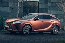 Lexus RX 450h+ (2023) review: front three quarter static, bronze car, house in background