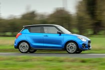 Suzuki Swift Sport (2023) review: side view driving shot, blue car, British B-road
