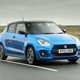 Suzuki Swift Sport (2023) review: front three quarter driving, blue car, British B-road