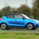 Suzuki Swift Sport (2023) review: side view driving shot, blue car, British B-road