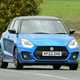 Suzuki Swift Sport (2023) review: front three quarter cornering, blue car, British B-road