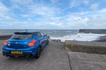 Suzuki Swift Sport: rear three quarter static, sea in background