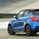Suzuki Swift Sport (2023) review: rear three quarter static close up, blue car, water in background