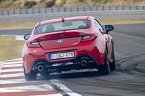 Toyota GR86 review: rear track driving, doing a massive skid, low angle, red paint