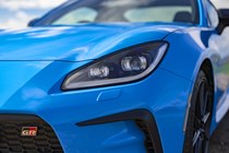 Toyota GR86 review: LED headlight detail shot, blue paint