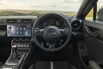 Toyota GR86 review: dashboard, steering wheel and infotainment system, black upholstery