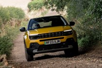 Jeep Avenger (2023) review: front three quarter driving, yellow paint, off-road track