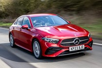 Mercedes A-Class Saloon, front three quarter tracking, high angle, red paint, wooded background