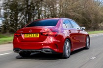 Mercedes A-Class Saloon, rear three quarter tracking, low angle, red paint, wooded background