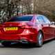Mercedes A-Class Saloon, rear three quarter tracking, low angle, red paint, wooded background