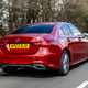 Mercedes A-Class Saloon, rear three quarter tracking, red paint, wooded background