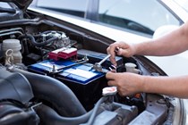Mechanic loosening earth connection on a car battery