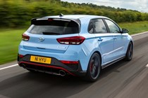 2023 Hyundai i30 N hatchback driving on a straight road. Photo taken from a tracking car of the rear.