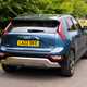 Kia Niro Plug-in Hybrid, rear three quarter driving, blue paint