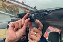Image of a man putting a dash cam in position