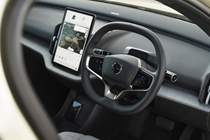 Volvo EX30 review (2024): infotainment system and steering wheel, black upholstery