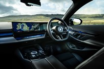 BMW i5 (2023) review: dashboard and infotainment system, black upholstery