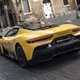 Maserati MC20 (2025) review: rear three quarter driving, yellow paint