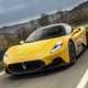 Maserati MC20 (2025) review: front three quarter driving, yellow paint, low angle