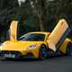 Maserati MC20 (2025) review: front three quarter static, yellow paint, doors open