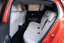 Fiat 600e rear seats, cream leather upholstery with embroidered Fiat motif