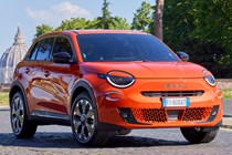 Fiat 600e front three quarter static, orange paint