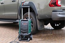 Bosch Fontus Pressure Washer next to pickup truck