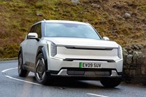 Kia EV9 review (2024): front three quarter cornering, silver paint, British country road